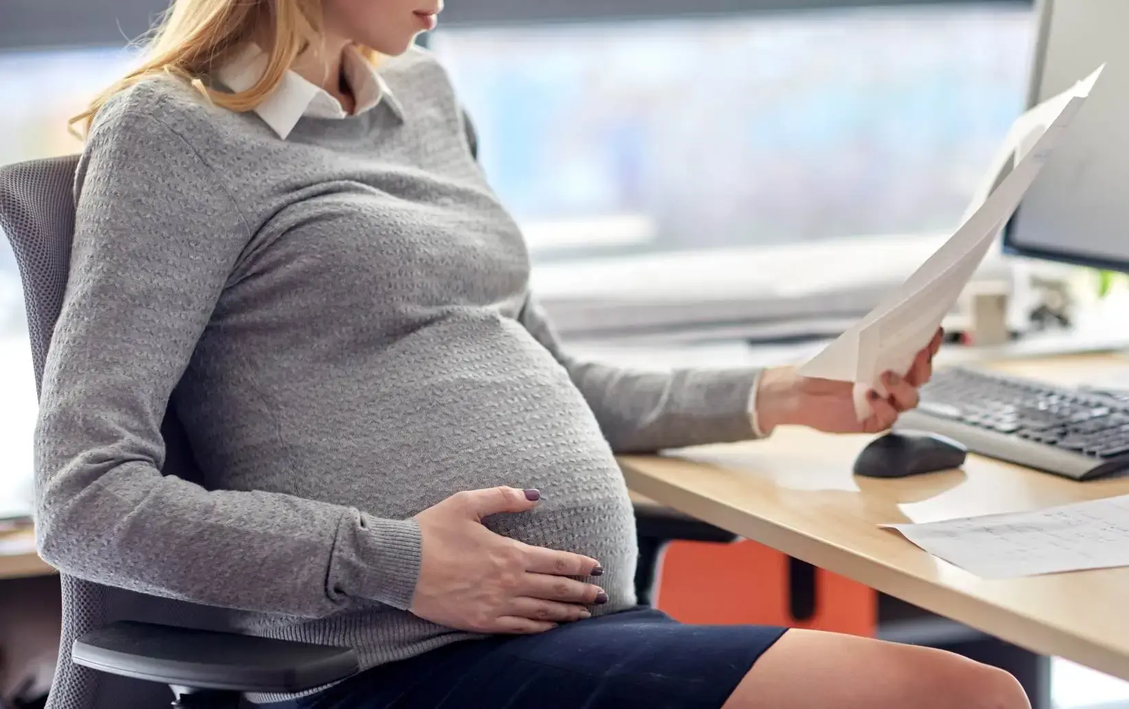 maternity leave -- a pregnant woman at work